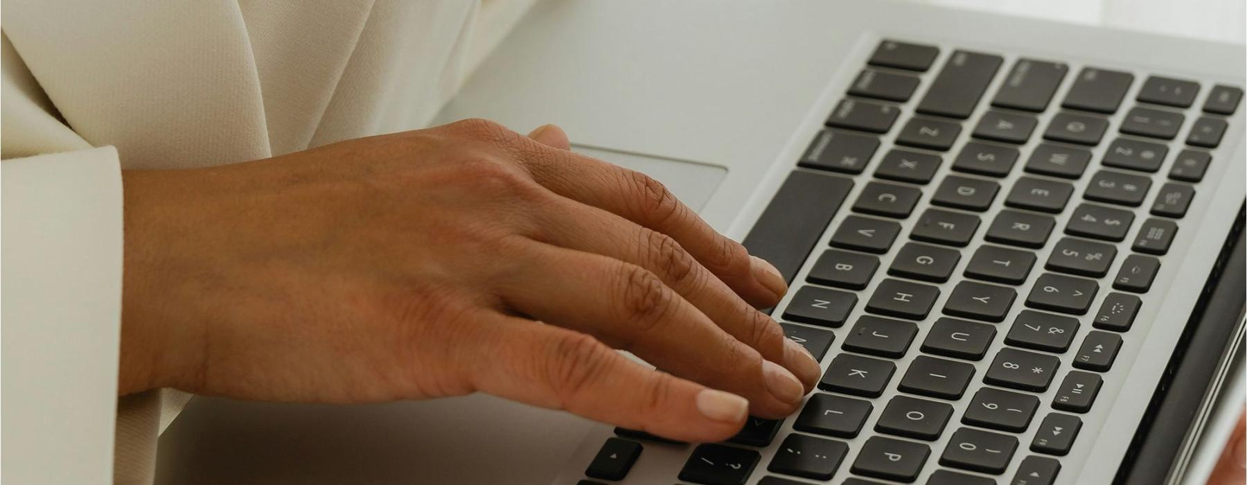 a person typing on a laptop