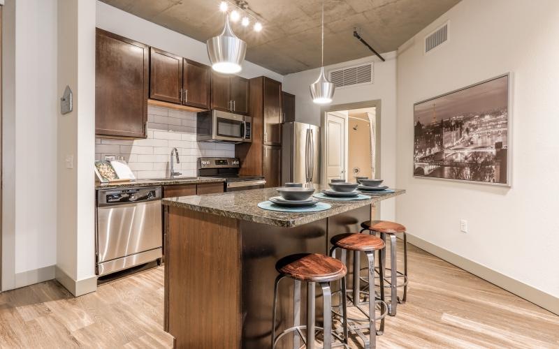a kitchen with stools and a bar stool